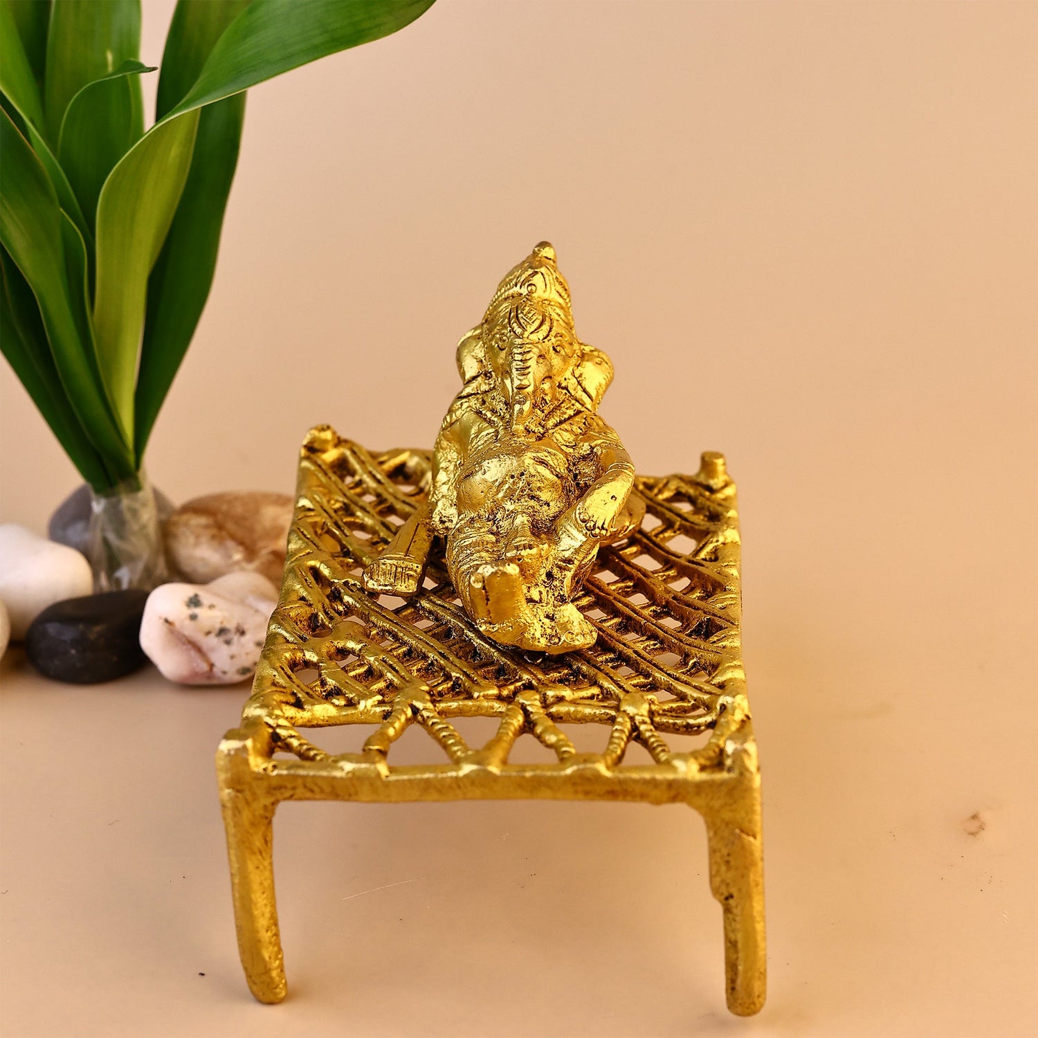 Brass Ganesha on Charpai