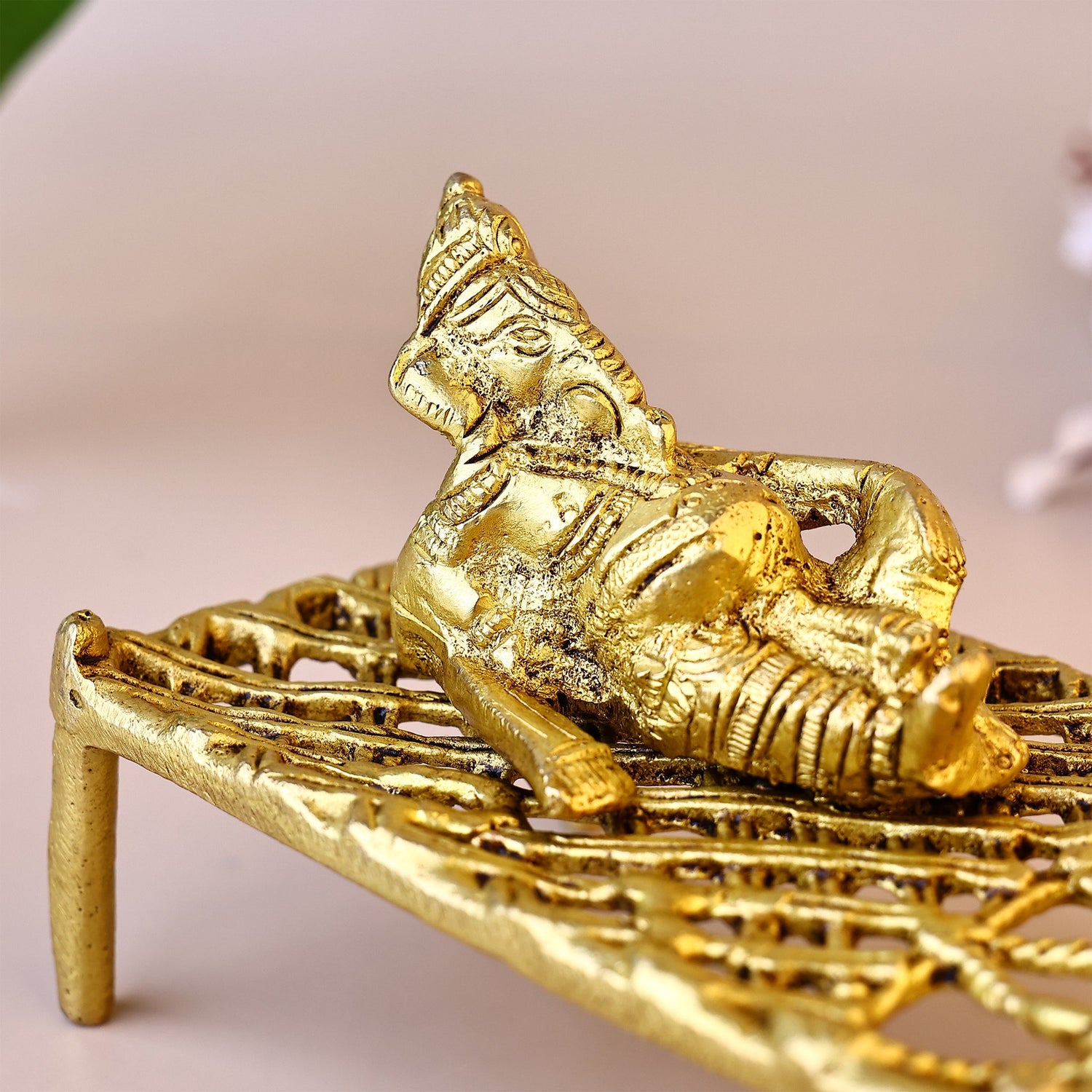 Brass Ganesha on Charpai